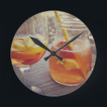 Sangria and Sunshine Rund Klocka<br><div class="desc">This image shows a refreshing glass and pitcher of citrus sangria, perfect for a warm day. The fresh slices of lemon and orange add bright colour and hint of natural sweetness. One glass sits ready to enjoy while sangria is being poured from a small glass pitcher beside it, perfect for...</div>