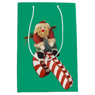 Santa Claus plays on candy can slide for fun.