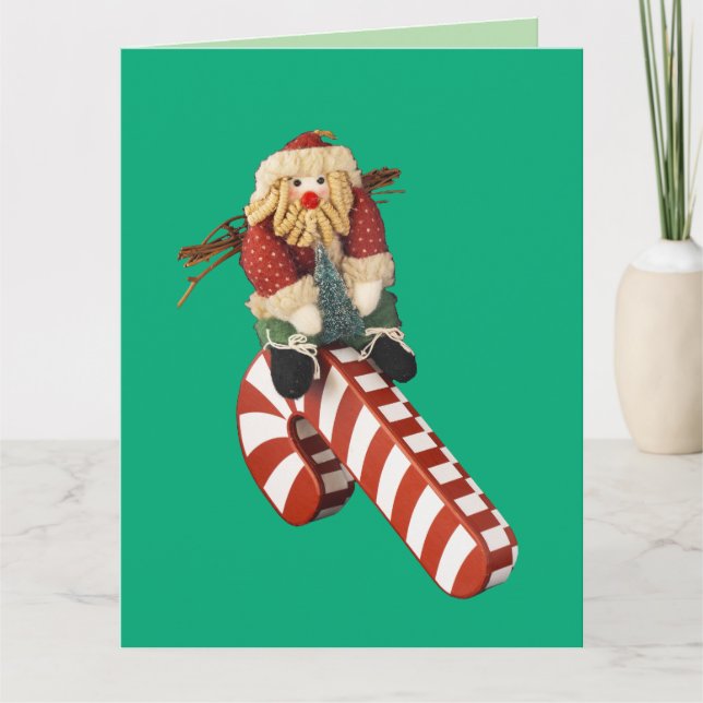 Santa Claus plays on candy cane slide for fun. Kort (Framsida)