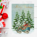 Santa Gifts in i sin Vintage FLAT Snö Träd Julkort<br><div class="desc">Underbart tomten i sin bil som färdas genom snö med vackert presenter som väntar på att bli distribuerad. Träd med snö har ställt in bakgrunden och ett guld God jul-meddelande. Anpassa på baksidan i ett charmerande helgdag ram.</div>