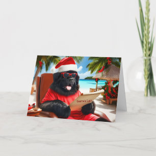 Santa on Beach som kontrollerar hans julkort Helgkort
