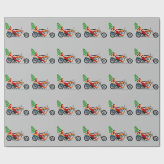 Santa på en motorcykel som slår in papper presentpapper