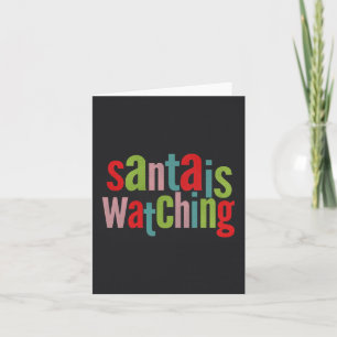 Santa tittar på färgad kalkbräda helgkort