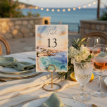 Santorini Wedding Table Numbers | Mediterranean  Bordsnummer<br><div class="desc">Guide your guests in style with these elegant Santorini-inspired wedding table numbers, designed to complement a romantic Mediterranean destination wedding. Featuring a soft watercolor coastal scene with ocean blues and warm sunset tones, these table numbers add a refined and cohesive touch to your reception decor. The clean layout with bold...</div>