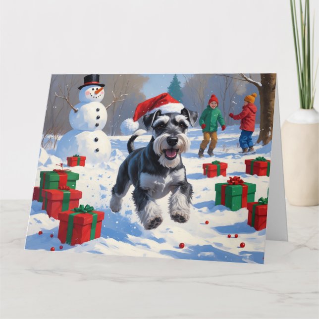 Schnauzer springar i snö med julhatt kort (Framsida)