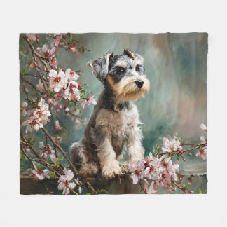 Schnauzer-valp bland vårens körsbärsblommor fleecefilt