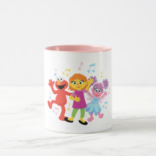 Sesame Street Julia, Elmo och Abby dansar Mugg