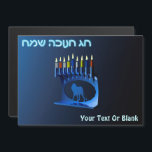 Shiny Blue Chanukkah Menorah<br><div class="desc">En moderniserande,  metallisk,  blå Chanukkah-menorah,  med en lejon i silhouette,  mot en mörk,  natteliknande bakgrund. Alla nio ljusen är tända. Den hebreiska text som lyder "Chag Chanukkah Sameach" (Lycklig Hanukkah) förekommer också i blått och vitt ljus. Lägg till ytterligare text.</div>