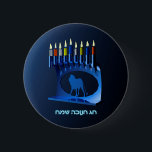 Shiny Blue Chanukkah Menorah Knapp<br><div class="desc">En moderniserande,  metallisk,  blå Chanukkah-menorah,  med en lejon i silhouette,  mot en mörk,  natteliknande bakgrund. Alla nio ljusen är tända. Den hebreiska text som lyder "Chag Chanukkah Sameach" (Lycklig Hanukkah) förekommer också i blått och vitt ljus.</div>