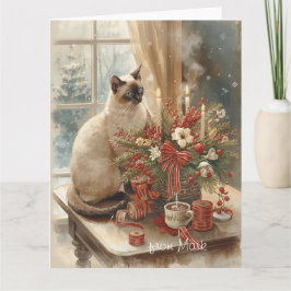 Siamesisk katt arrangerar blommor vinter jul  kort