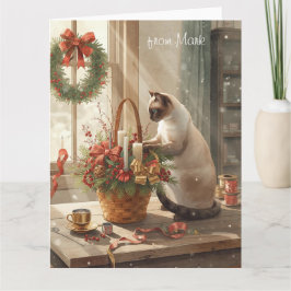 Siamesisk katt som arrangerar blommor för Vinterju Kort