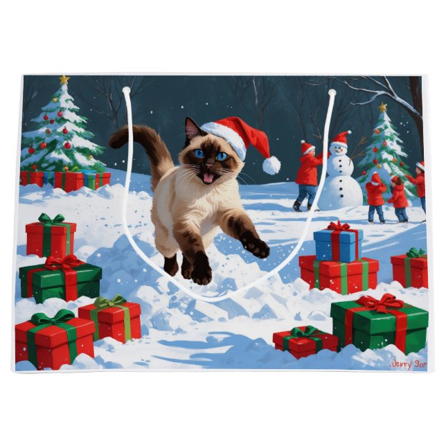 Siamesisk katt springer i snö med julhatt (Framsidan)