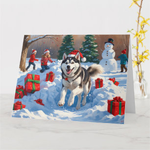 Siberisk Husky som springer i snö med julhatt Kort