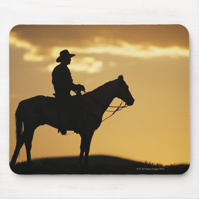 Silhouette cowboy på horseback vid solnedgång elle musmatta (Framsidan)