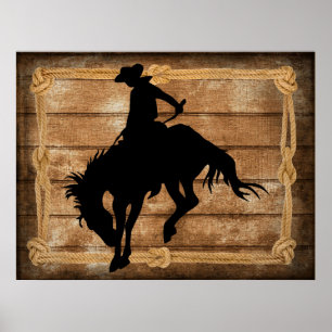 Silhouette cowboyen på en buckande bronkohäst poster