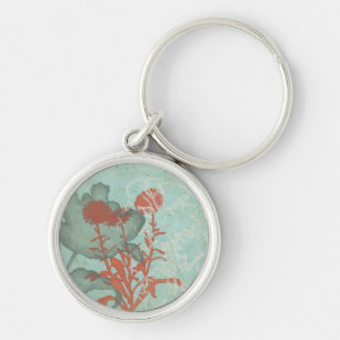 Silhouette med Röda blommor i bakgrunden Rund Silverfärgad Nyckelring