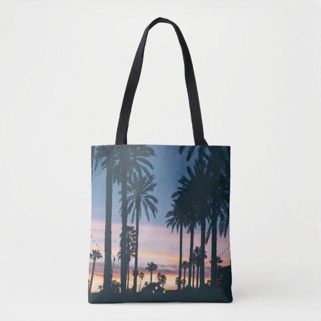 Silhouette of houses beside palm trees and pathway tygkasse (Framsida)
