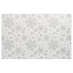 Silver snöflingor på vitt tyg