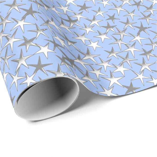 Silver stjärnor, på blek blå presentpapper (Rullad Hörn)