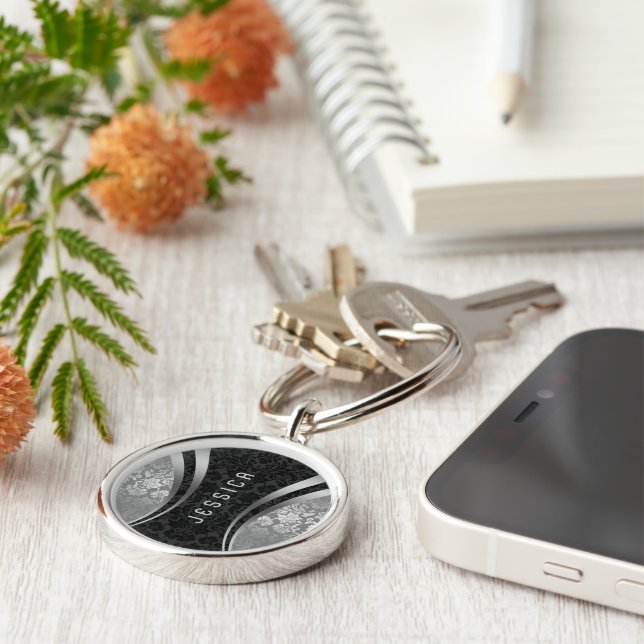 Skador för elegantens svarta och Silver-Blommigt Rund Silverfärgad Nyckelring (Sidan)