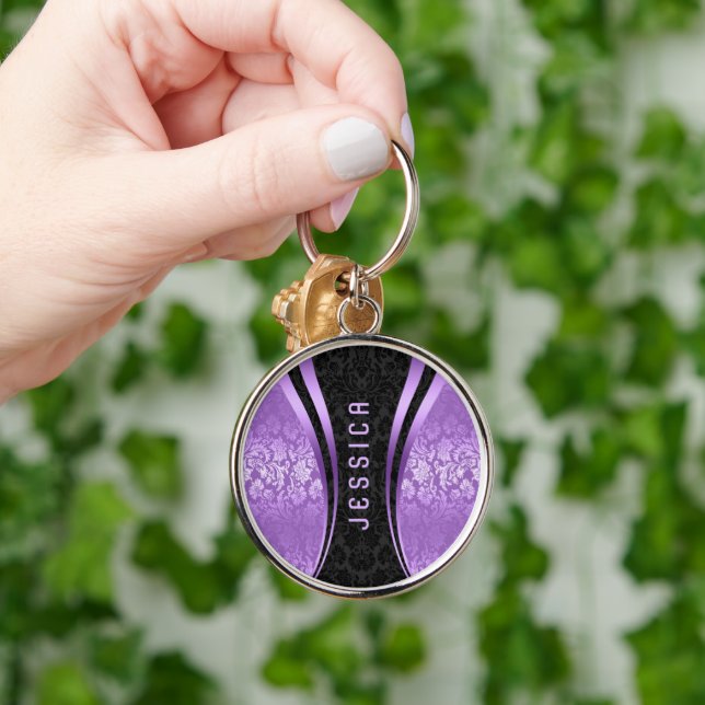 Skador på Blommigten Black and Lila Tones Rund Silverfärgad Nyckelring (Hand)