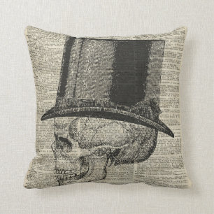 Skallen med victorianhatten stencilerar över den kudde