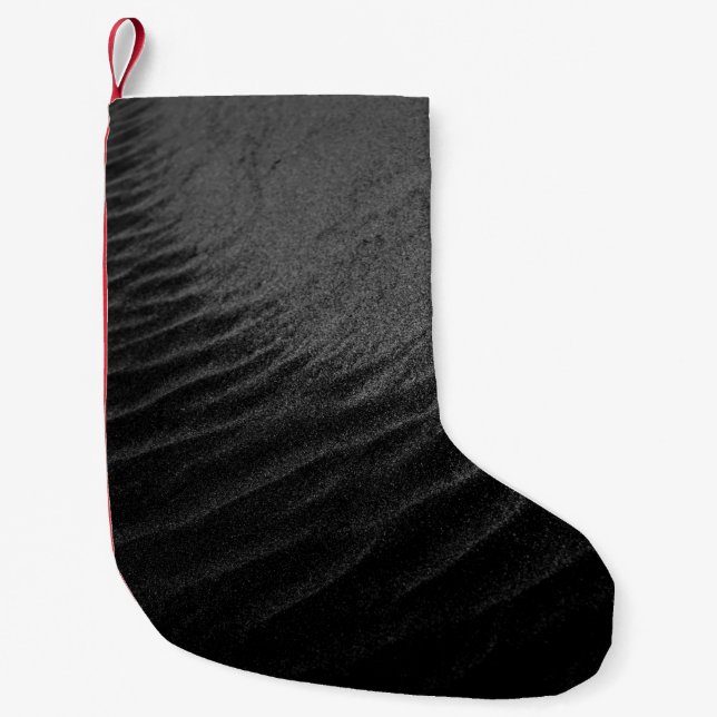 Skalstensfotografi av sand liten julstrumpa (Framsidan)