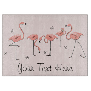 Skärbräda med rosa flock av flamingos text