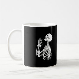 Skeleton ber om hjälp på en kaffemugg