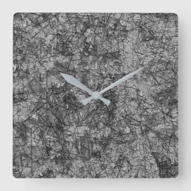 Skinnad på ett lätt fläckat grått och svart fyrkantig klocka (Framsida)