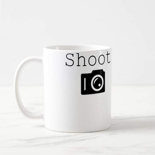 Skjuta. Fotofotograf 	 Med Kamera Kaffemugg (Vänster)