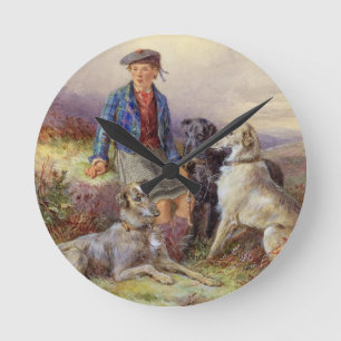 Skotsk pojke med wolfhounds i en höglands- landsc rund klocka