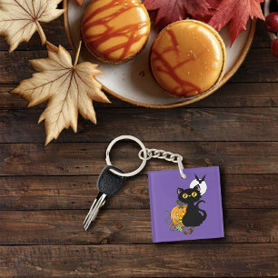 Skrämmande lila söt svart katt Halloween-pumpa