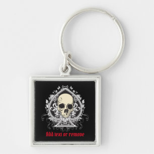 Skull och spadar från spelkort. fyrkantig silverfärgad nyckelring