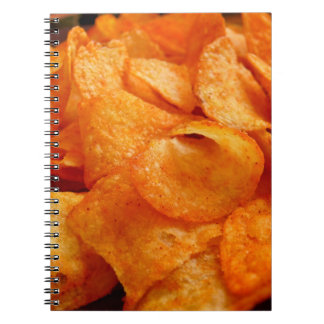 Slut på juicy, krispy, chip på svart tallrik. anteckningsbok