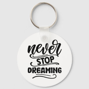 Sluta aldrig drömma inspirationsincitattypografi nyckelring