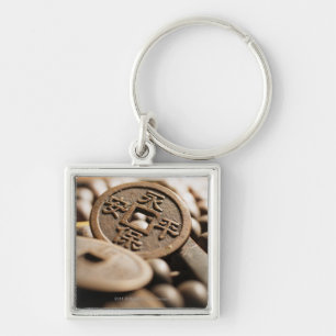 Slutet av kinesen myntar upp fyrkantig silverfärgad nyckelring