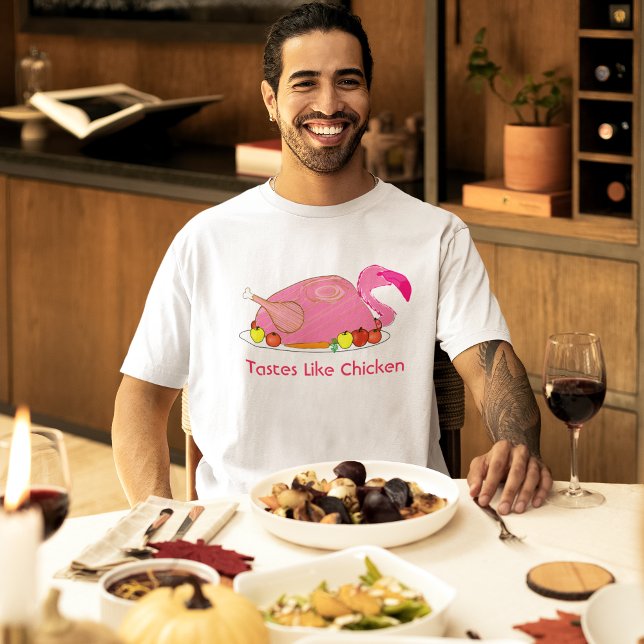 Smakar Som Kyckling Rolig Flamingo Tee (male model at a holiday dinner wearing pink flamingo tastes like chicken funny t-shirt)