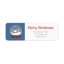 Snö-jordklotet med litet hus -