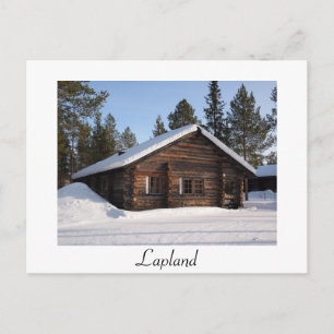 Snö-täckt loggstuga i vykort för text på Lappland