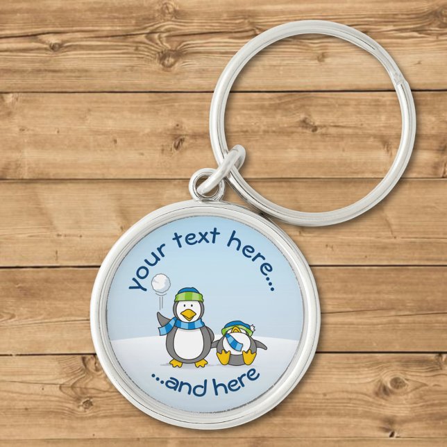 Snöballerande penguiner rund silverfärgad nyckelring (Skapare uppladdad)