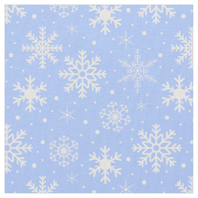 Snöflingor på isblått tyg (Närbild)