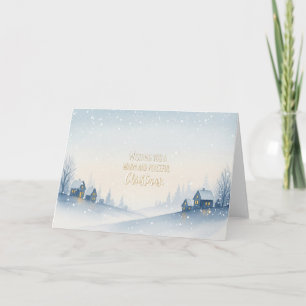 Snöiga vinterbackar by med varmt julfirande helgkort