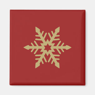 Snowflakedesignguld på rött magnet