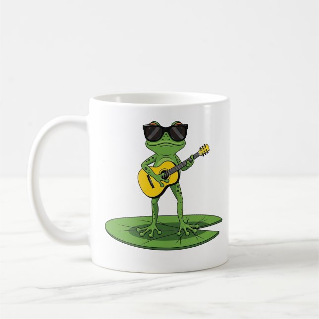 Snygg seriefigur av groda som spelar gitarr kaffemugg (Vänster)