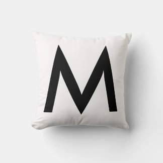 Snygg svart monogram på vit kudde