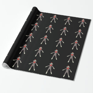 Sock monkey som slår in papper presentpapper