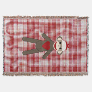 sock monkey vävd filt på rött mönster