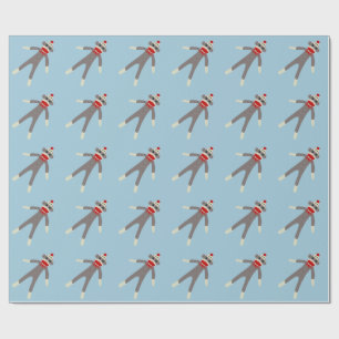 Sock monkeyjul som slår in papper presentpapper