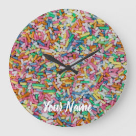 Sockersprinkler: färgad bakgrundsgåva stor klocka